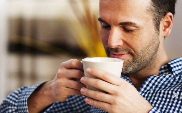 A man drinks a drink of fireweed tea to increase potency